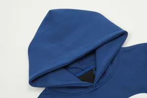 Blue hoodie detail, fleece lined fabric, cozy hood, size M collar tag, casual streetwear style.