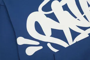 Detailed view of the blue Y2K style streetwear hoodie with white graffiti letter print.