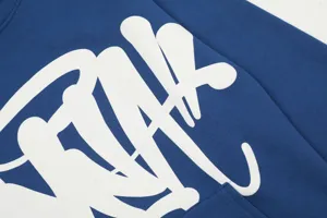 Blue fleece hooded sweatshirt detail featuring white graffiti letter print, high street style.