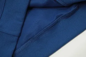 Blue fleece hoodie fabric detail, soft inner lining and neat stitching craftsmanship.