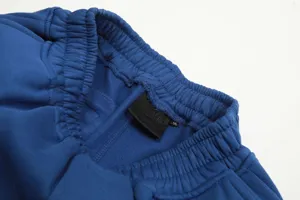 Blue fleece sweatpants detail, elastic waistband, comfort casual streetwear shorts.