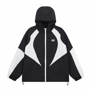 Close-up detail view of the black and white color-blocked hooded windbreaker jacket.