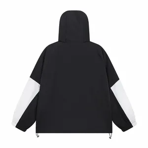 Black and white colorblock hooded windbreaker jacket detail showcasing the sleeve design.