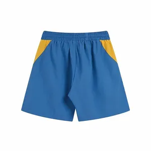 Detail view of casual color block shorts featuring blue and yellow contrast stitching waist.