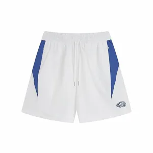 Close-up detail of white casual sports shorts with blue side panel block and contrast embroidery.