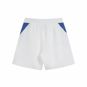Detail view of casual white sports shorts featuring striking blue side panel color blocking.