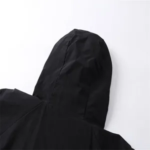 Black windbreaker jacket detail shot, unisex hooded outerwear for daily casual street style.