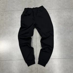 Black casual sweatpants detail view, comfortable fleece-lined fabric, ideal for daily wear.
