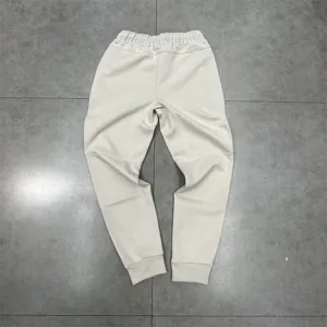 Casual fleece-lined sweatpants detail view, solid off-white color with elastic waistband.