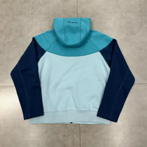 Detail view of the color-blocked fleece-lined hooded sweatshirt with back embroidery lettering.