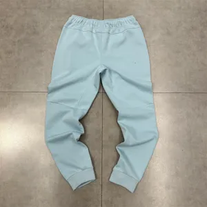 Light blue casual sweatpants for men and women, comfortable elastic waist with stylish panel details.