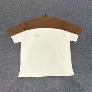 Brown and off-white color block short sleeve t-shirt detail view, casual streetwear style.