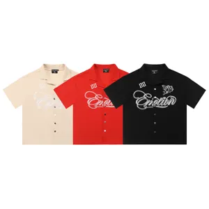 Detailed view of the embroidered waffle camp shirt featuring angel and letter graphics.