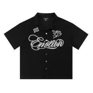 Detailed view of black waffle knit short sleeve shirt with embroidered cupid and text.