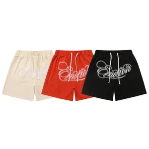 Casual waffle knit shorts detail view featuring embroidered lettering and adjustable drawstring waist.