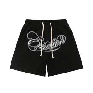 Black waffle knit shorts featuring long white drawstrings and detailed Emotion embroidery.