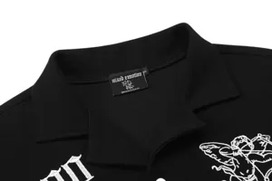 Black waffle knit polo shirt with white cupid embroidery, stylish streetwear casual top detail view.