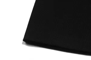 Black waffle knit fabric detail closeup of short sleeve shirt and shorts set for men and women.