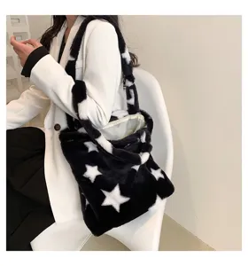 Plush tote bag detail view showing soft faux fur material and star pattern design.