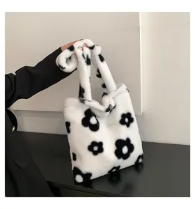 Detail view of the black and white floral plush tote bag, highlighting soft texture.