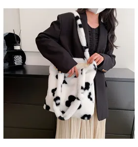 Fuzzy plush shoulder tote bag for women, cozy cow print fuzzy handbag, stylish casual winter purse.