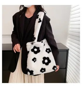 Fluffy plush tote bag with cute black and white flower pattern, soft furry shoulder bag style.