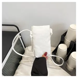 Vue detaillee du sac bandouliere pour telephone blanc minimaliste, tissu doux et leger.
