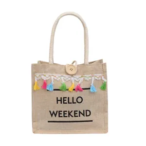 Sac cabas en jute tendance avec pompons, sac à main bandoulière et fourre-tout femme.