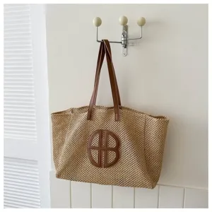 Large capacity straw woven tote bag with brown leather shoulder straps and vintage design.
