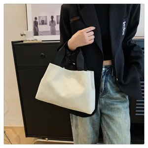 Gros plan d'un sac à main élégant en velours côtelé blanc dans un décor tendance au quotidien.