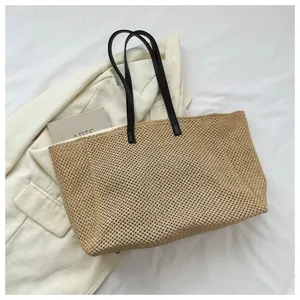 Large capacity straw woven tote bag, casual beach shoulder bag with black handles.