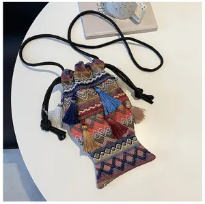 Sac bandoulière ethnique tissé en forme de poisson avec glands colorés et cordons noirs.
