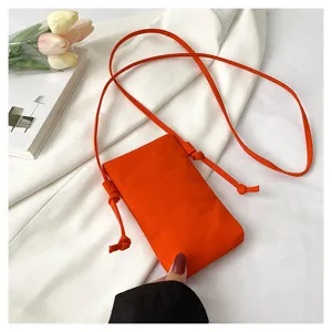 Sac bandoulière minimaliste en toile orange, petit sac d'épaule décontracté pour femme.