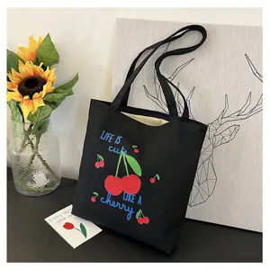 Zwarte canvas tote tas met leuke kersenborduurwerk en casual ontworpen stijl voor dagelijks gebruik.