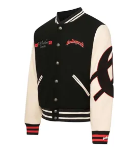 Black and white contrast varsity jacket with embroidery, snap buttons, and ribbed trim.