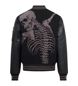 Back detail view of black varsity jacket featuring detailed skull skeleton embroidery design.