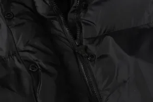 Detailed shot of black puffer jacket front zipper and snap buttons streetwear winter warm coat