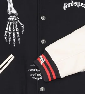 Streetwear black white varsity jacket with skeleton embroidery and metal skull buttons.