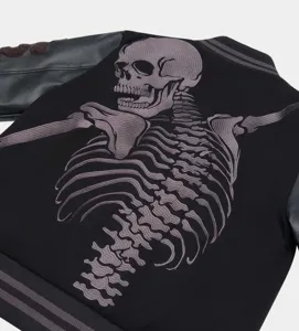 Detailed view of the black streetwear varsity jacket featuring large embroidered skeleton on back.