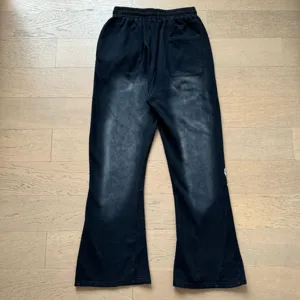 Black flared sweatpants for men and women, casual elastic waist trousers with vintage wash effect.