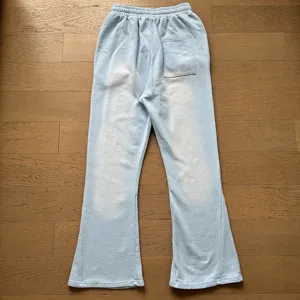 Light blue flared sweatpants detail showing elastic waistband and vintage washed texture.