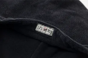 Detailed view of the washed streetwear hoodie collar tag, featuring vintage gothic numbering.