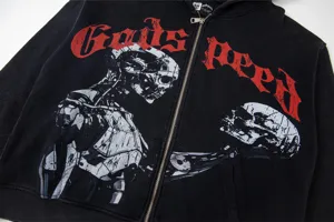 Detailed view of the black zip-up hoodie featuring mechanical skull graphic and red gothic text.