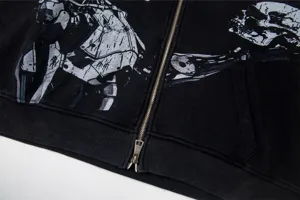 Detailed view of black washed zip-up hoodie with distressed skull graphic print streetwear jacket.