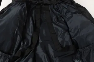 Black puffer jacket interior detail with shoulder straps, high quality winter outerwear.