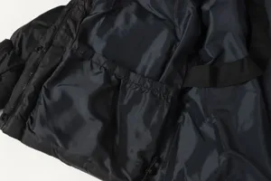 Winter jacket interior detail, showing soft padded lining, elastic pocket, and carrying strap.