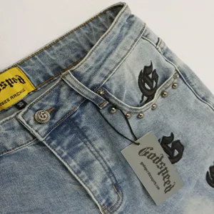 Godspeed streetwear denim jeans detail view, high street style light wash cotton fabric close up.