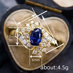 Vintage sapphire oval cluster ring detail showing exquisite gold design and sparkling stones.