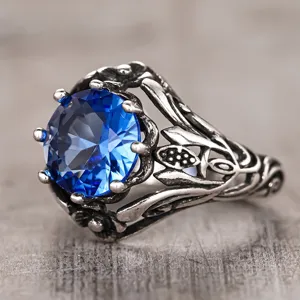 Close-up detail of vintage gothic dark style retro ring with stunning blue round gemstone.