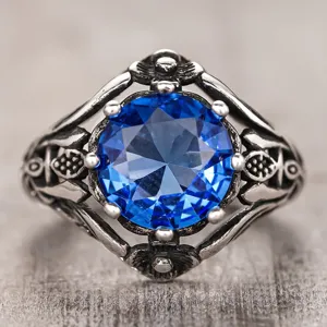 Detailed view of the vintage blue gemstone ring with intricate gothic silver texture.